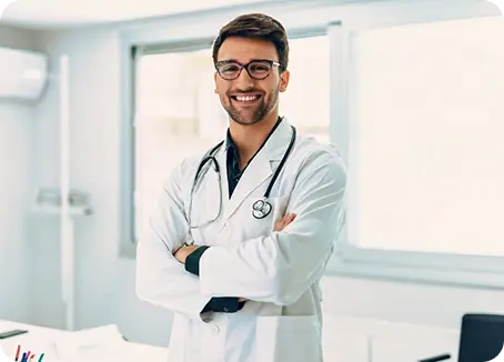 male doctor stands at a desk
